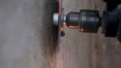 Circular saw cuts a nail in the wall Stock Footage 154248339