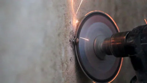 Circular saw cuts a nail in the wall Stock Footage 154248371