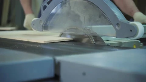 A circular saw cuts through a hardboard wood panel. Stock Footage 225139088