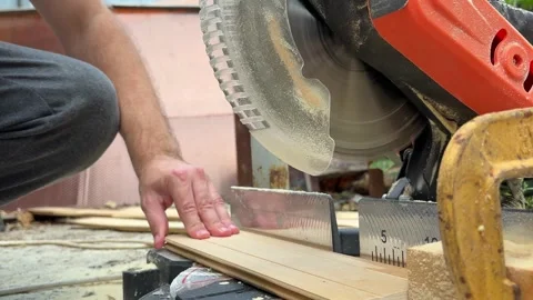 Circular saw for cutting wooden panel made of fiberboard in workshop. Carpenter Stock Footage 282365409