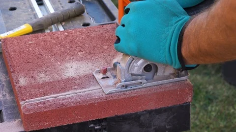 Circular saw electric.Worker cutting paving tiles for laying on the terrace Stock-Footage 120910110