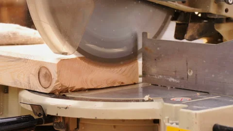 Circular saw in the process of operation. The carpenter cuts off the edges of a Stock Footage 130365613