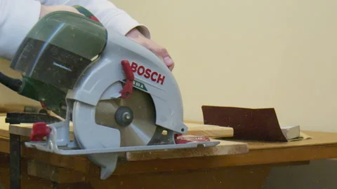 A Circular Saw in Slow-Motion sawing through a wood board Stock Footage 291696846