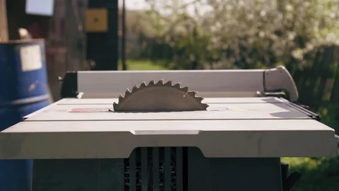 Circular saw starts to work. Slow motion rotating disk of industrial stationary Stock Footage 90098659