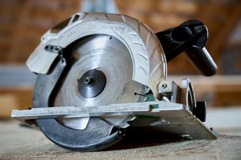 Circular saw on workbench in workshop. Professional power tool for cutting wo Stock Photos
