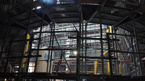Circular scaffolding structure inside building core with steel platforms and Stock Footage 332809921