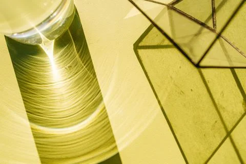 Circular shadow and light pattern from light passing through water bottle Stock Photos
