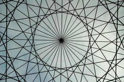 Circular shaped metallic structure with a sky background Stock Photos