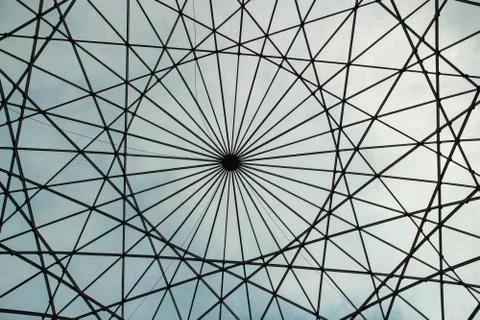 Circular shaped metallic structure with a sky background Фото