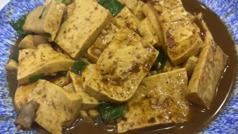 Circular Shot of Braised Old Tofu in Soy Sauce with Scallions Видео 333723287