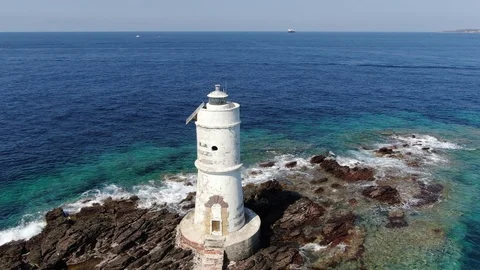 Circular shot with a drone on the lighthouse on the coast of Sardinia Stock Footage 115437513
