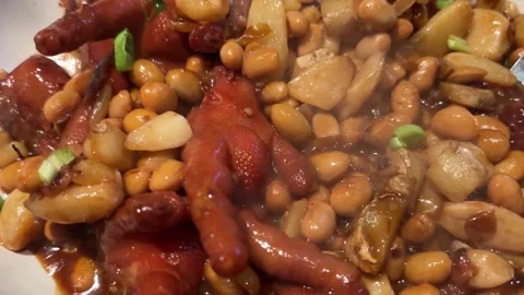Circular slow push-in of steaming braised chicken feet with soybeans Vídeos de archivo 332382584