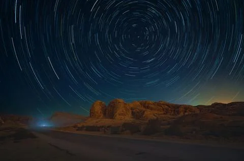 Circular Star Trails Over the Desert Rock Formations at Night Near Wadi Mus.. Stock Photos