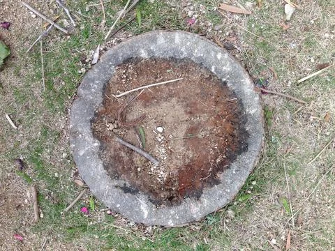 Circular stone ring filled with soil and sticks Stock Photos