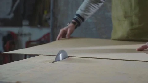 Circular table saw cutting wood sheet at carpenter workshop in slow motion Stock Footage 83765608