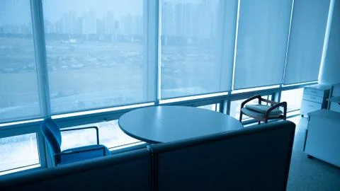 Circular table, two chairs, and partition. Stock Photos