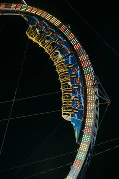 Circular thrill ride at state fair at night. Stock Photos