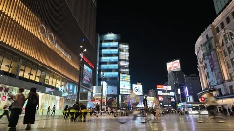A circular timelapse of a plaza between buildings and a shopping complex with Stock Footage 309268771