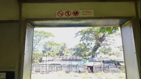 Circular train entrance in motion, rules signs, cargo train, Yangon, Myanmar Stockbeeldmateriaal 78277555