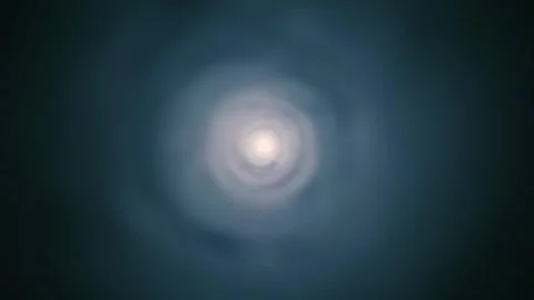 A circular tunnel formed by bright light and waves of smoke goes in the distance Stock Footage 313210207