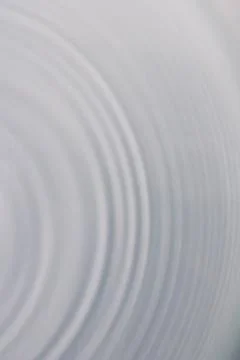 Circular wave motion in a fluid system. blue gray background for a liquid pus Stock Photos