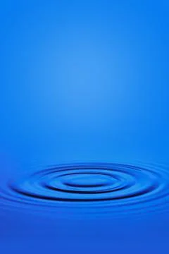Circular waves on the surface of the blue water. Stock Photos