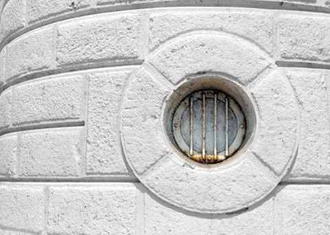 Circular window, also know as bull eye, on a lighthouse wall Stock Photos