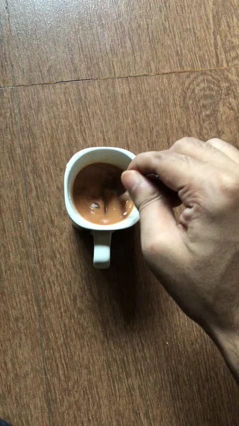 Circulating in the tea cup for mixing by spoon Stock Footage 132504666