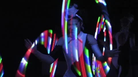 Circus act - Woman dancing with glowing hoops HD Stock Footage
