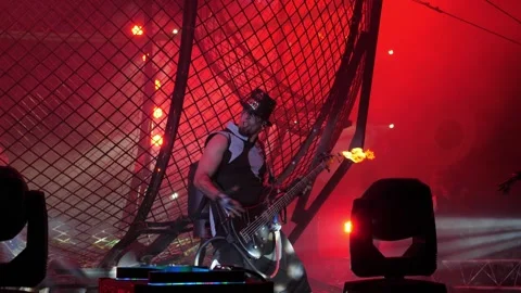 The circus actor holds a guitar in his hands, from which fire flies out. Circus. Stock Footage 310656364