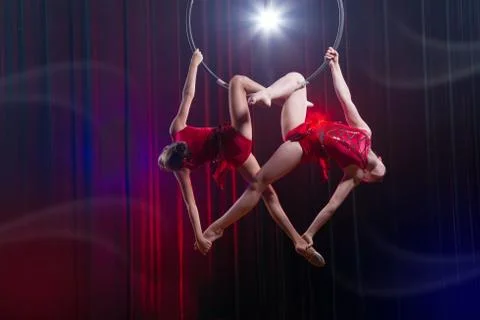 Circus actress acrobat performance. Two girls perform acrobatic elements in the Stockfoto's