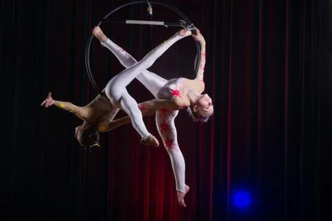 Circus actress acrobat performance. Two girls perform acrobatic elements in the Stockfoto's
