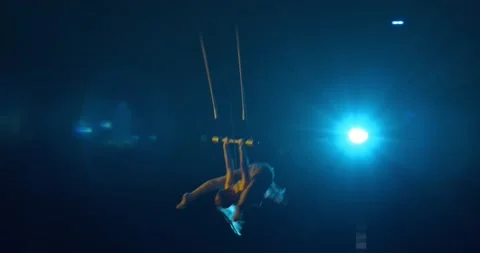 Circus artist is performing high up at the ceiling of the circus, show, 4k Stock Footage 147191313