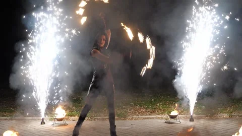 A circus artist performs a fire dance in the darkness, slow motion. Fire show. Stock Footage 295189709
