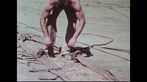 Circus canvas sections are laced together by a man. Stock Footage