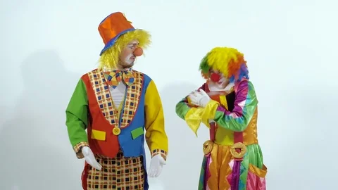 Circus clown taking a box away of another clown Stock-Footage 70284133