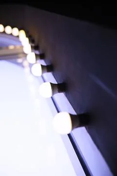 Circus lights in a row on red ceiling. Lamp hanging from the ceiling in the b Stock Photos