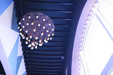 Circus lights in a row on red ceiling. Lamp hanging from the ceiling in the b 写真素材