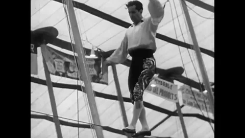 A circus perfomer performs his act on the tight wire in 1949. Stock Footage 79518352