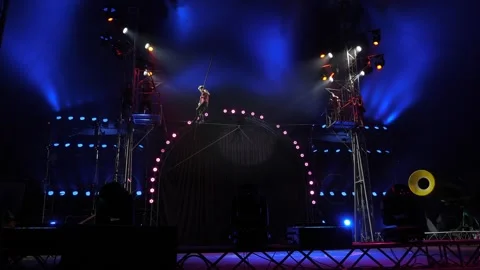 Circus performance of acrobats-tightrope walkers on a tightrope in the circus. Stock Footage 312436247