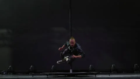 A circus performer is doing tricks on a pole Stock Footage 286140279