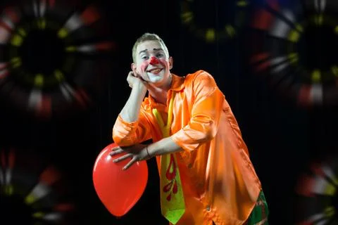 Circus сlown performs number. A man in a clown outfit with a balloon Stock Photos