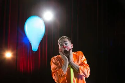Circus сlown performs number. A man in a clown outfit with a balloon Stock Photos