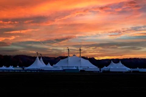 Circus tent under a warn sunset and chaotic sky without the name of the circu Stock-Fotos