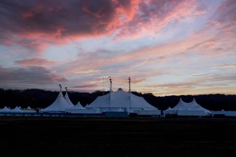 Circus tent under a warn sunset and chaotic sky without the name of the circu Stock Photos