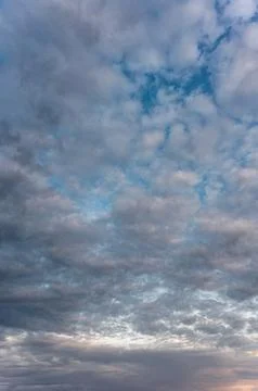 Cirrocumulus clouds and gaps of blue sky. Stock Photos