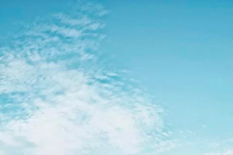 Cirrocumulus clouds in the clear bright blue sky in the afternoon Stock Photos