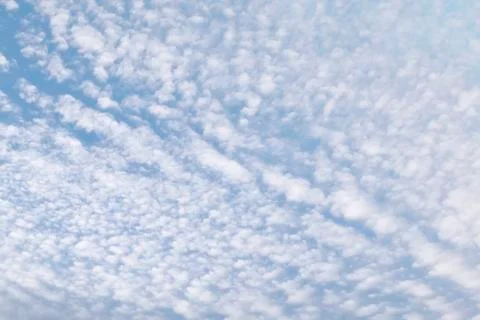 Cirrocumulus clouds in the clear bright blue sky in the afternoon Stock Photos