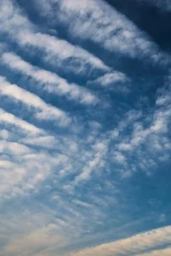 Cirrocumulus clouds at high altitude on a clean summer sky. Stock Photos