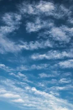 Cirrocumulus clouds at high altitude on a clean summer sky. Stock Photos